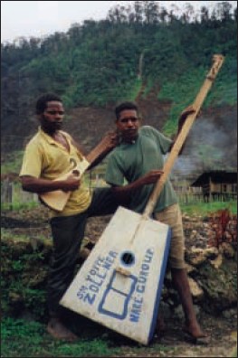 a picture of a Martin Backpacker guitar jam session with the world's last stone-age tribe on Irian Java, New Guinea in East Indonesia